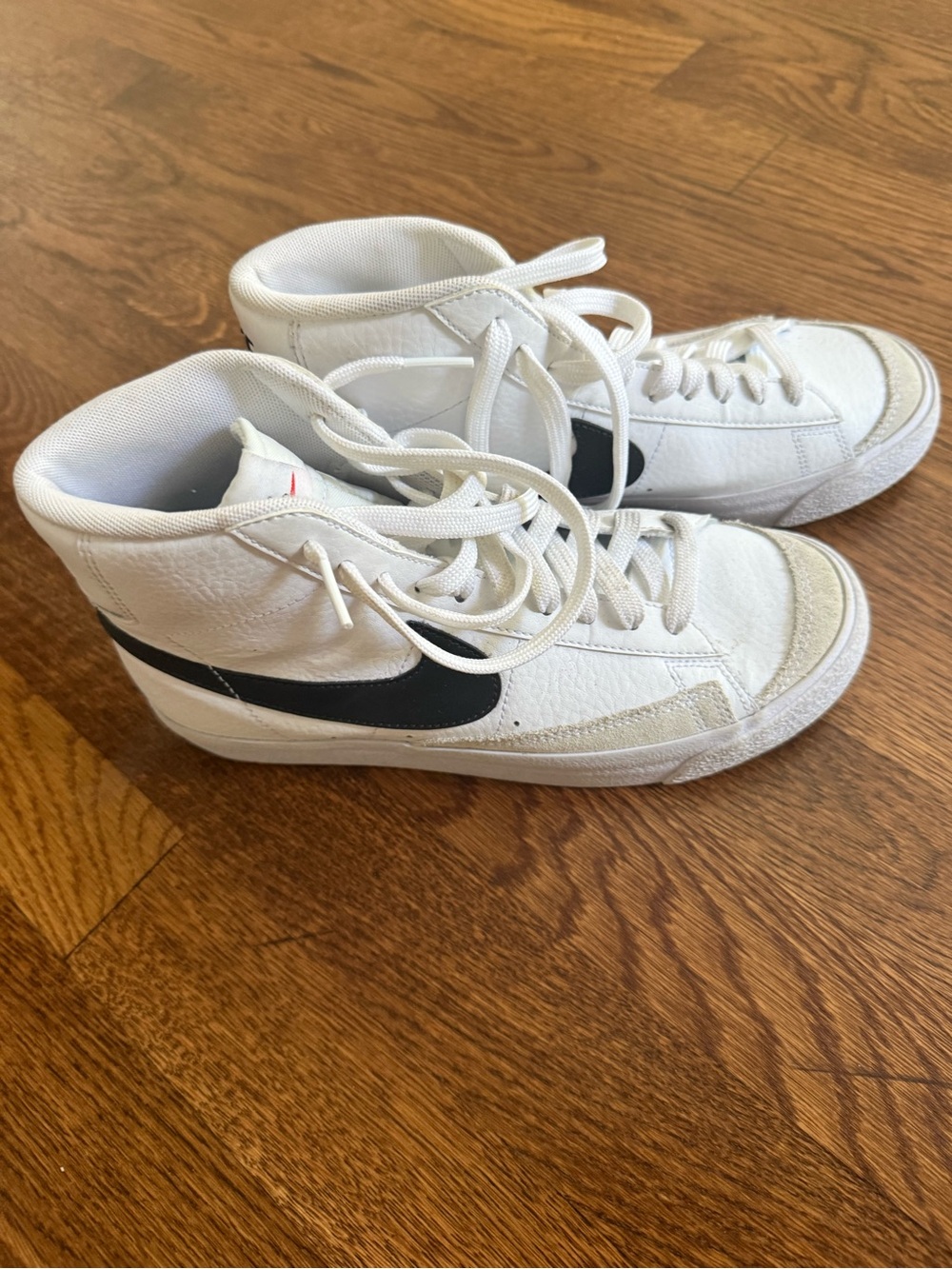 Nike White High-Top Sneakers with Black Swoosh